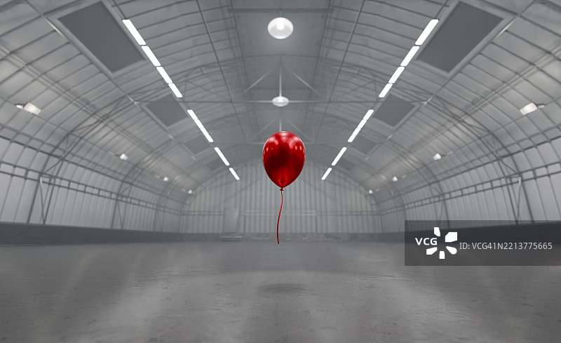空仓库中间漂浮着一个红色气球图片素材
