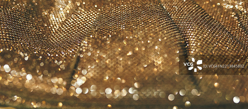 闪闪发光的金色纹理特写，带有闪烁的高光图片素材