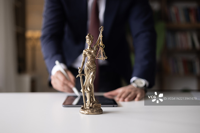数字平板电脑，法官或法律顾问律师正在审查和签署法律文件。图片素材