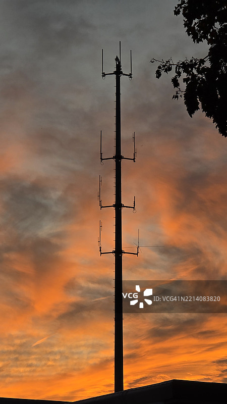 低角度视图下的路灯剪影映衬着橙色天空，达里恩，康涅狄格州，美国图片素材