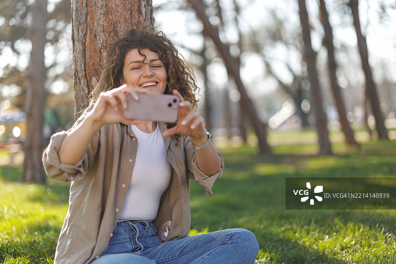 放松的女性在城市公园自拍图片素材