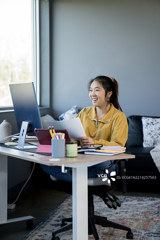 年轻专业人士在舒适的现代家居环境中远程工作图片素材