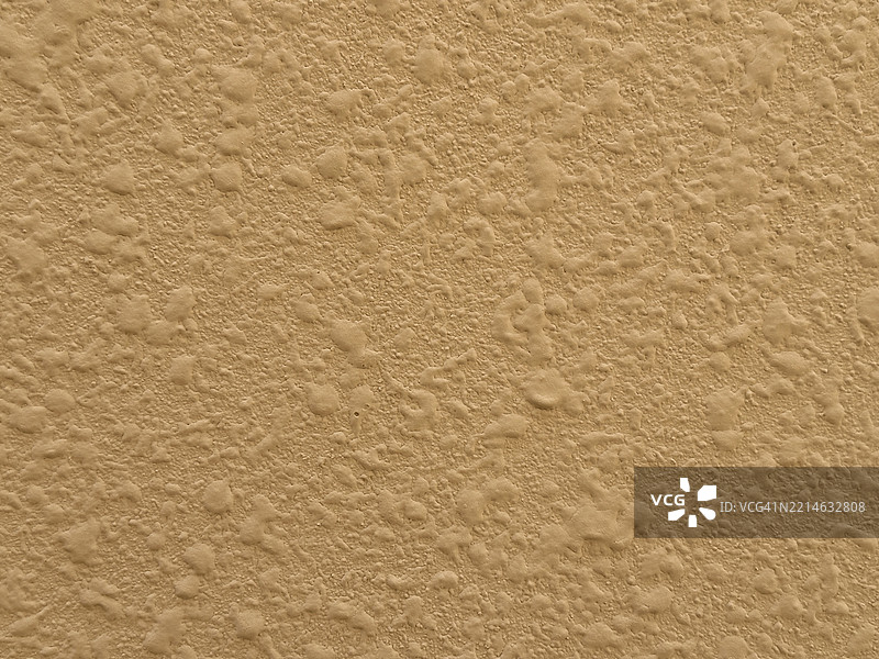 粗糙的米色灰泥墙面纹理特写图片素材
