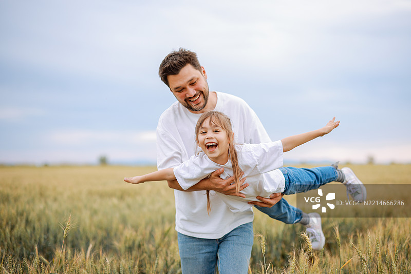 快乐的孩子在户外与爸爸一起玩耍图片素材