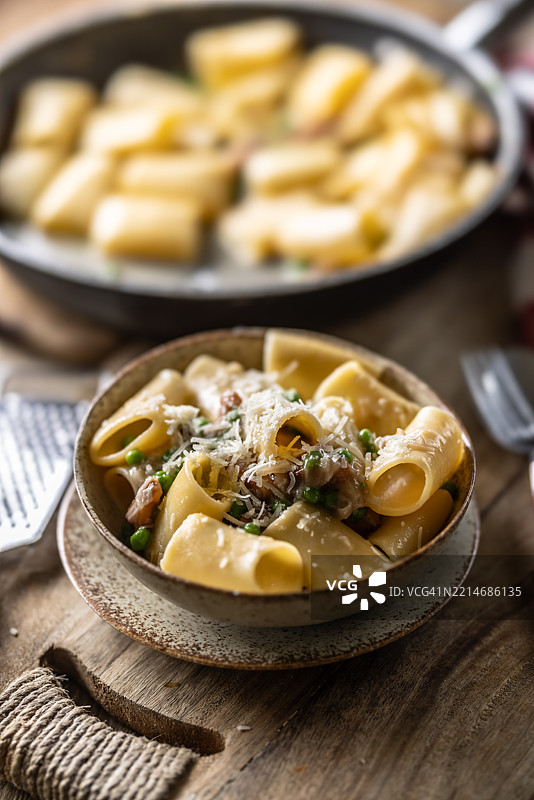 典型的意大利面卡拉马塔配培根、新鲜豌豆和帕尔马干酪。图片素材