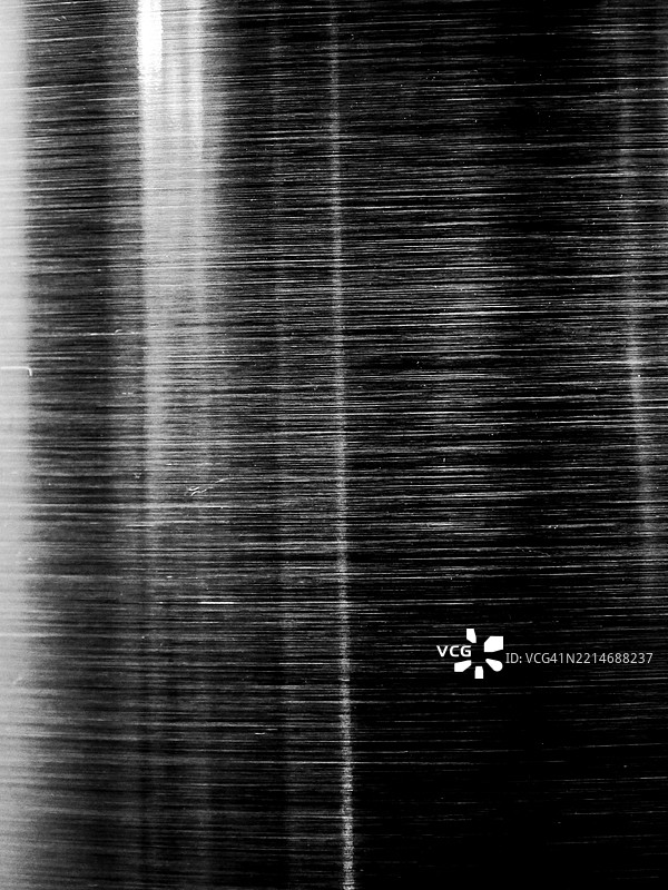 闪亮的、有棱纹的铝板,灰色且深色。粗糙的质地。黑白。全画幅 4:3。比利时布鲁塞尔。图片素材