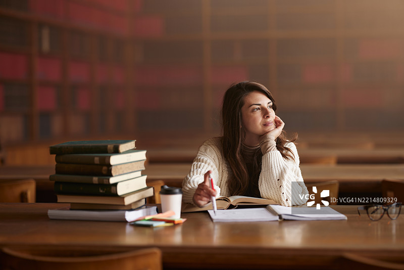在图书馆里认真学习的女学生。图片素材