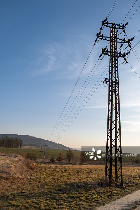 日落时分的高大金属电力杆与电缆图片素材