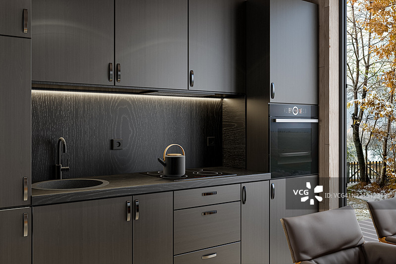 现代紧凑型厨房，配有深色木橱柜和点缀台面图片素材