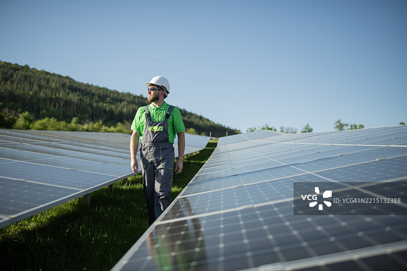 成功的光伏工程师在光伏电站内行走。图片素材