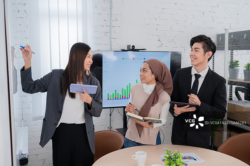 亚洲女商人向年轻同事展示市场调研数据，以便记录计划和想法的库存照片图片素材