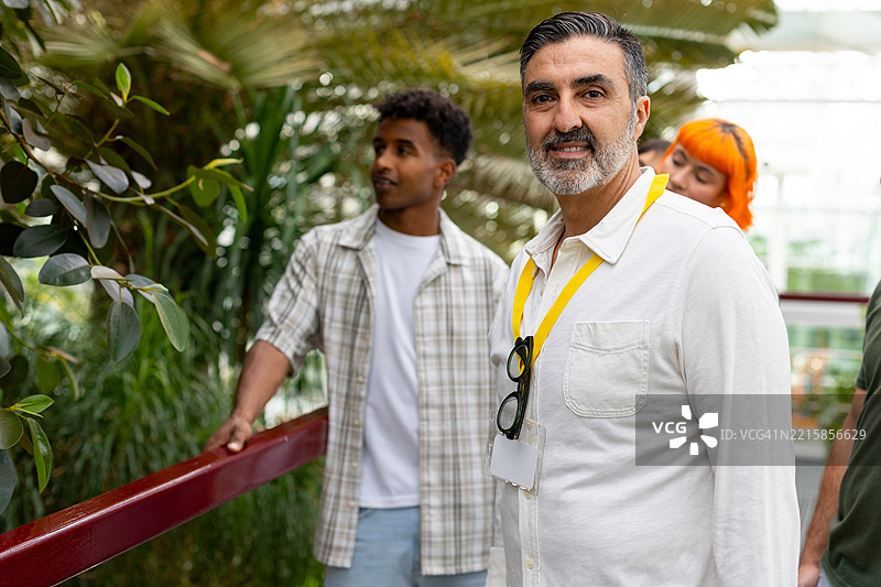 成熟的教授带领学生参观植物园图片素材