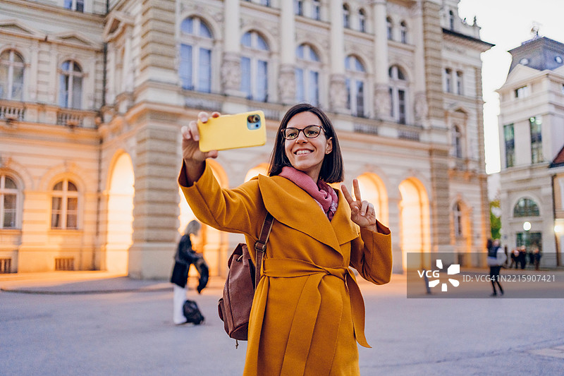 一位年轻女性在城市中使用手机图片素材