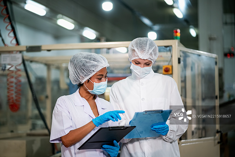 检查员正在罐头食品工厂检查罐头。图片素材