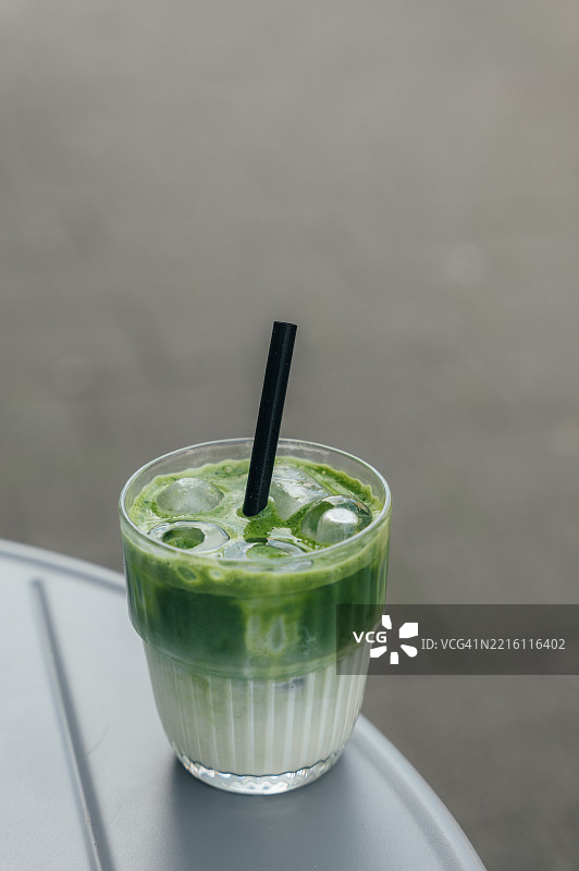 户外桌子上放着冰镇抹茶拿铁图片素材