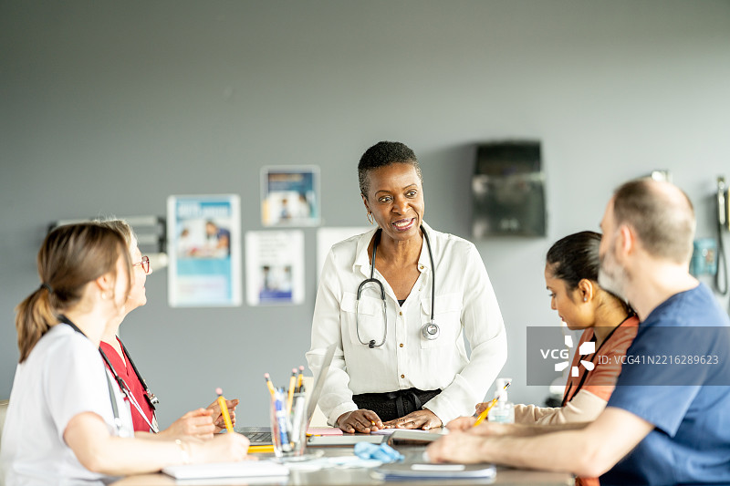 现代医疗机构中由资深医生领导的医疗团队合作图片素材