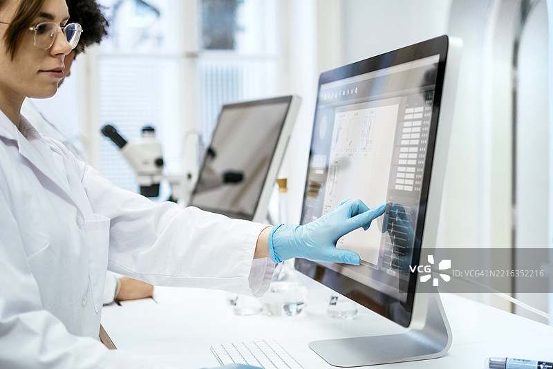 年轻的白人女性学生在大学实验室进行研究图片素材