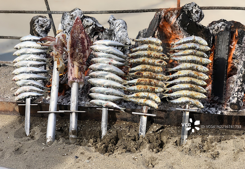西班牙海滨餐厅高角度拍摄的传统火焰烹饪新鲜海鲜图片素材