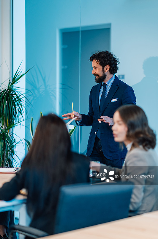 中年男商人在现代办公室主持会议图片素材