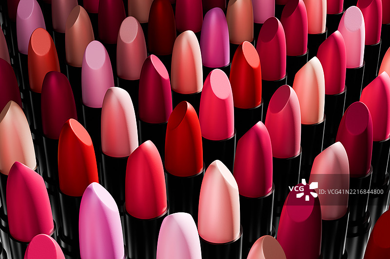 生动的多彩粉色和红色口红以时尚的图案排列，突显其光泽质感和丰富色彩。时尚、美容背景。化妆品。非常适合化妆行业的视觉效果。图片素材