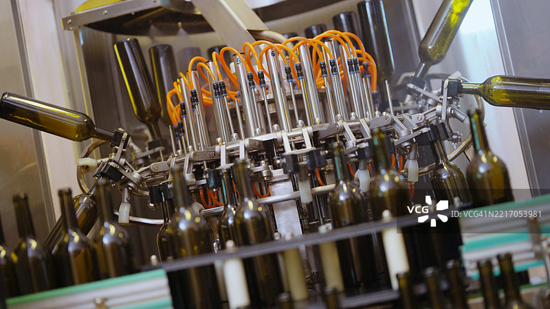 在酒厂的传送带上灌装葡萄酒瓶图片素材