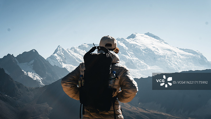 年轻男子向冰川山脉徒步旅行图片素材