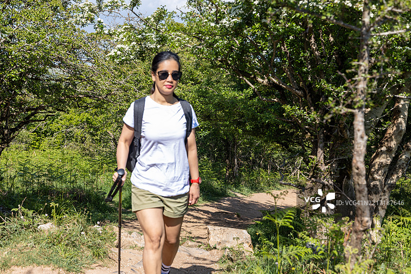 年轻女性在英国萨默塞特的切达峡谷徒步旅行图片素材