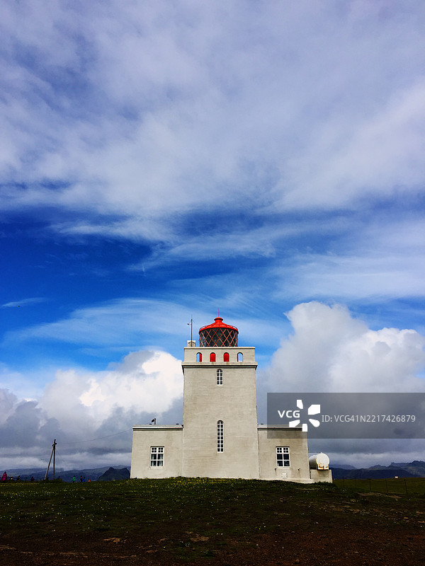 迪尔霍拉伊灯塔在生机勃勃的冰岛天空下图片素材