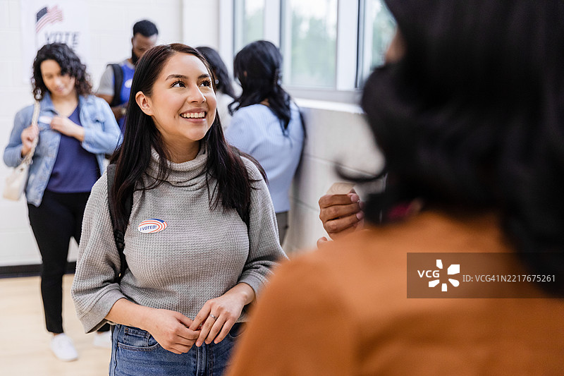 年轻的拉丁裔女性在投票后微笑图片素材