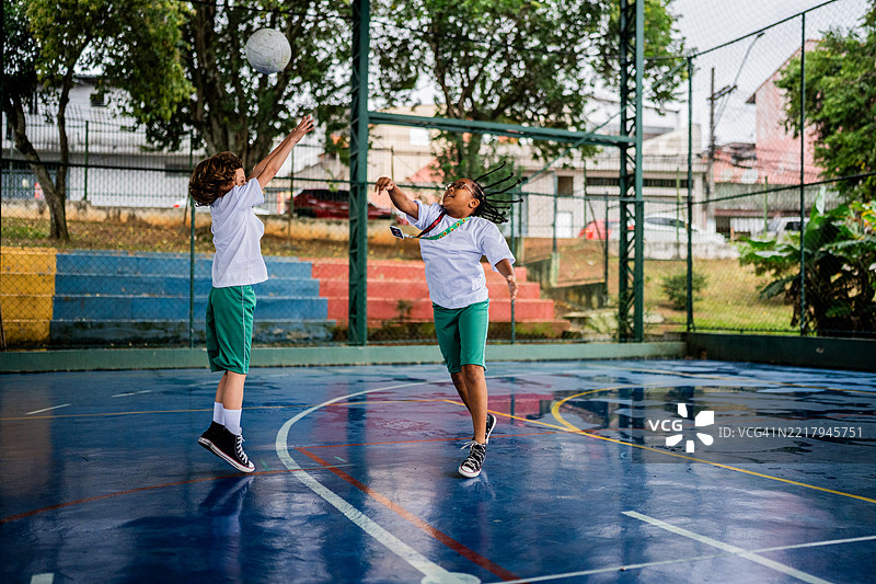 孩子们在学校的体育场上上体育课时玩躲避球图片素材