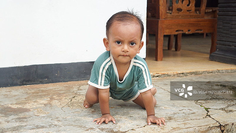 专注的孩子在铺好的地面上玩耍图片素材