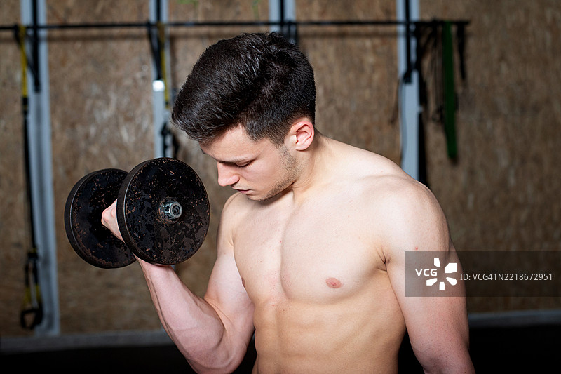 男性运动员在健身房举重锻炼图片素材