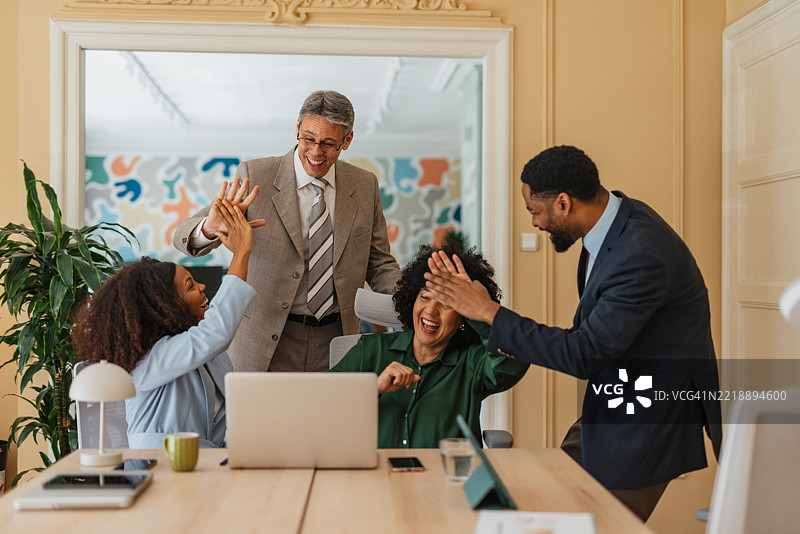 办公室里庆祝成就的击掌手势图片素材