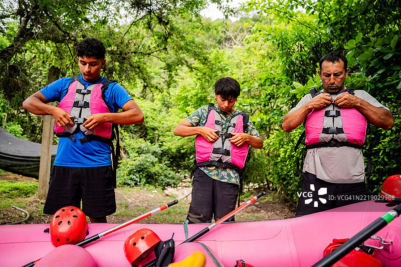 朋友们穿上救生衣，准备进行激流泛舟图片素材