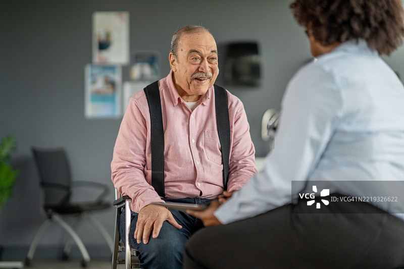 现代办公室中专业人士与老年人友好的互动图片素材