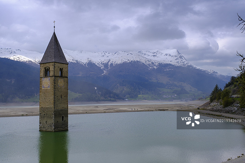 意大利南蒂罗尔维恩斯高地区雷申山口的雷申湖阿尔特格劳恩教堂塔楼遭遇恶劣天气图片素材