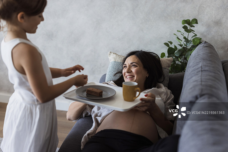 女孩为怀孕的妈妈准备小吃图片素材