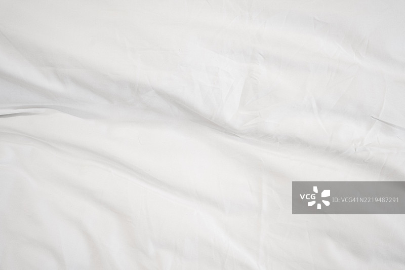 白色布料的纹理特写。纺织品的背景。图片素材