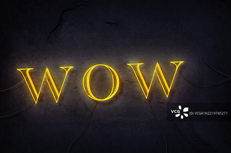 “WOW”字样在黑暗背景下发出明亮的霓虹灯光。图片素材