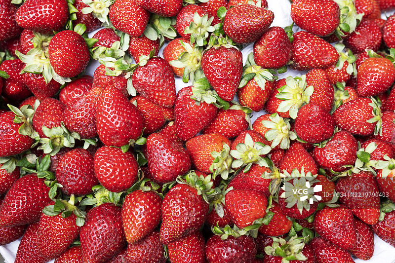 在葡萄牙马德拉的市场摊位上出售的新鲜成熟草莓图片素材