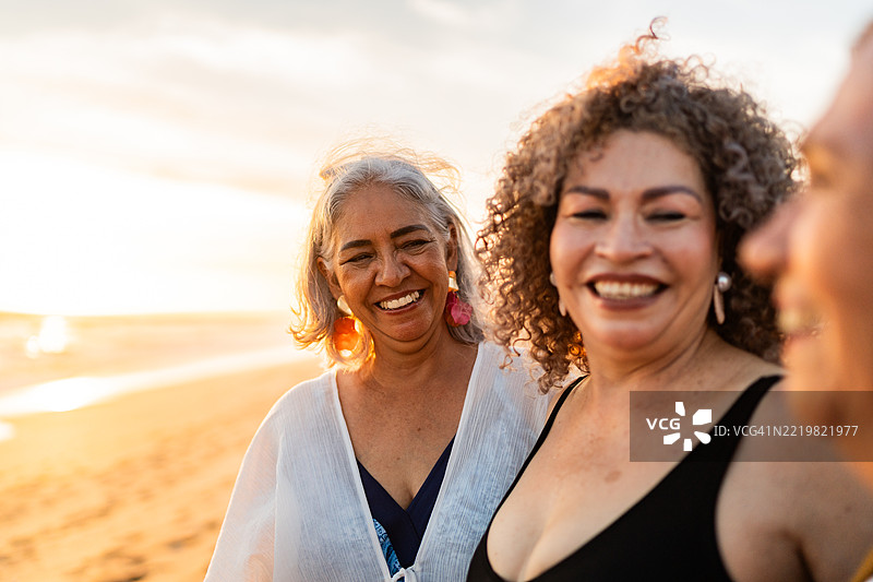 海滩上几位年长女性朋友在交谈图片素材