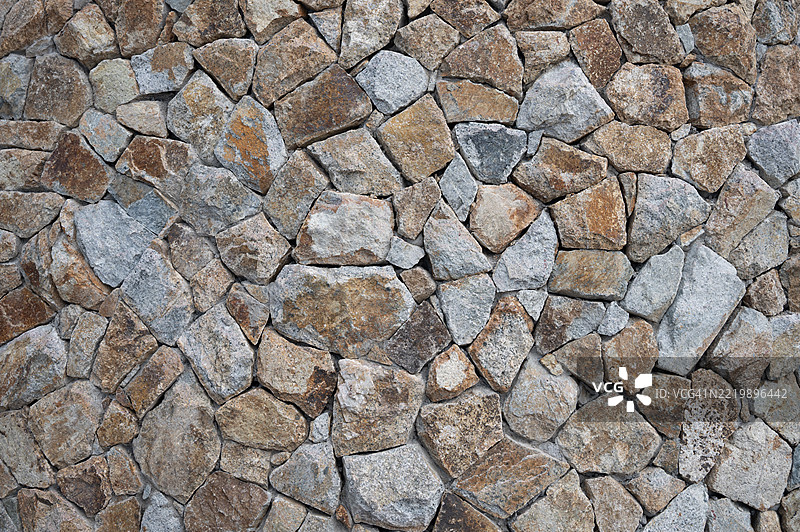 一面灰色的石头乡村风格墙壁。图片素材