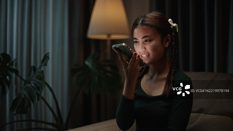 青少年在智能手机上询问人工智能语音。图片素材