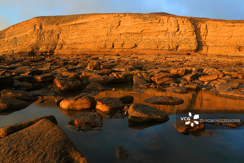 冬季在南威尔士布里真德的达纳文湾，悬崖上的金色晚霞图片素材