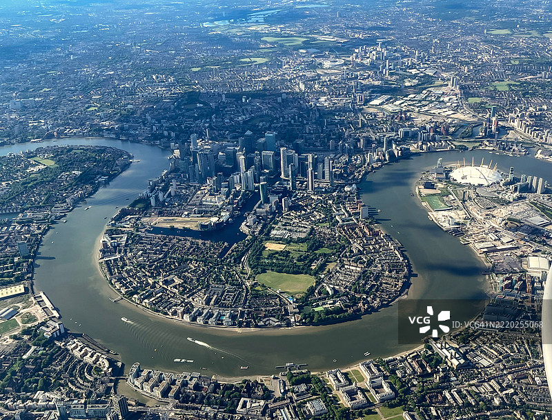 伦敦英格兰的狗岛空中图像，背景是金丝雀码头的摩天大楼和泰晤士河上完美的马蹄形弯道。图片素材