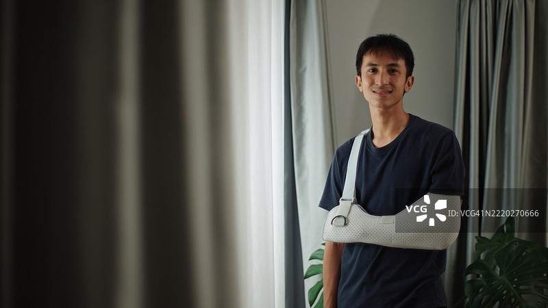 戴着手臂石膏的男子肖像。图片素材