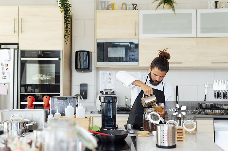 男性厨师在餐厅厨房准备咖啡图片素材