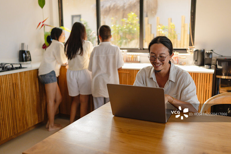 亚洲男子在度假期间远程工作图片素材