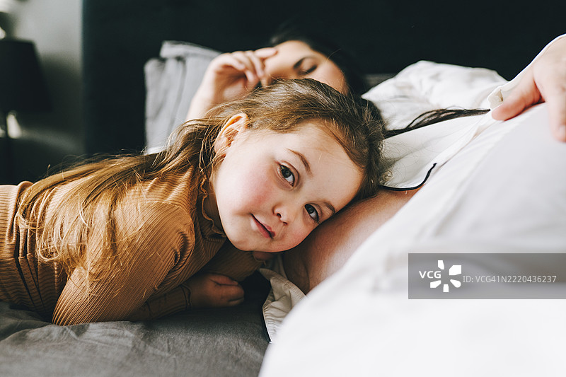 怀孕的母亲和女儿在家中亲密互动图片素材