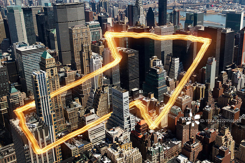 Light-streak directional arrow passing around buildings in Manhattan, New York图片素材